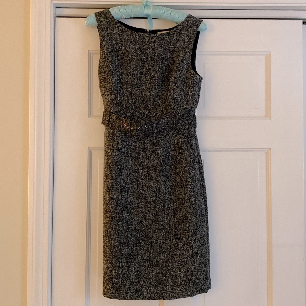 Sleeveless gray dress with belt.
